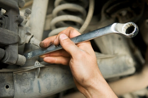 Mechanic at work with a spanner